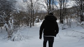 Man walking on snow in forest 
