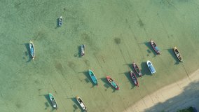 Amazing aerial Top view Longtail fishing boats in the tropical sea at Rawai beach Phuket Thailand Beautiful sea surface High quality video from drone camera