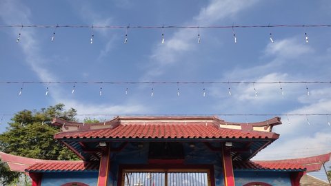 Parakan - Jan 25, 2022 - 4k time lapse cloudy blue sky over the gate of chinese temple, 4k time lapse cloudy sky