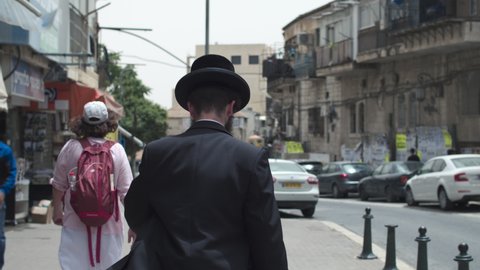 An orthodox Jew walking down Mea Shearim Street., Jerusalem, Israel - 7 may 2021