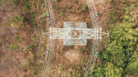 Transmission tower, power tower or electricity pylon. Consist of steel structure framing to support or carry cable, high-voltage powerline or overhead power line. For electrical grid in aerial view.
