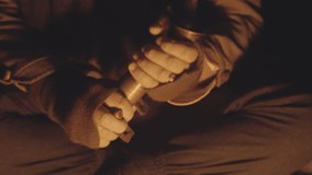 Handheld Close Up Shot Of Man Preparing Vintage Coffee Grinder At Campfire In Cave At Night, Iceland - Powered by Shutterstock - Get 15% off with code: PIKWIZARD15