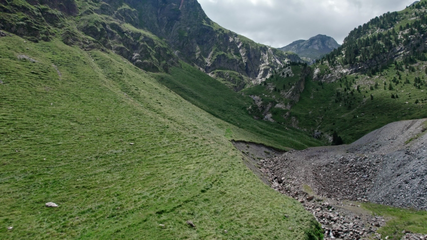 A car road on a hillside in a valley of high mountains. A vacation trip through a mountain range.