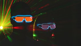 The man and woman in the futuristic glasses on the color rays background