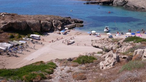 Sassari, Italy, Europe - July 23 2021: tourists on vacation on the beach of Porto Palmas.