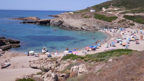 Sassari, Italy, Europe - July 23 2021: tourists on vacation on the beach of Porto Palmas.