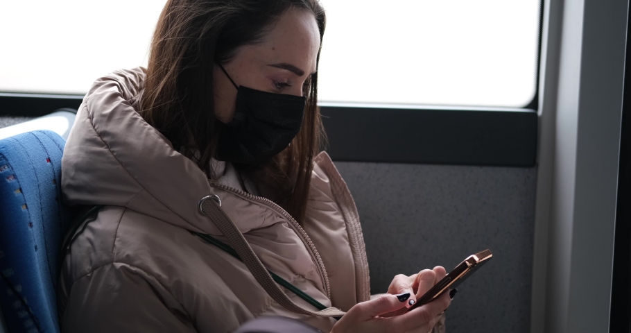 Woman wearing protective face mask using mobile phone in bus Royalty-Free Stock Footage #1085961341
