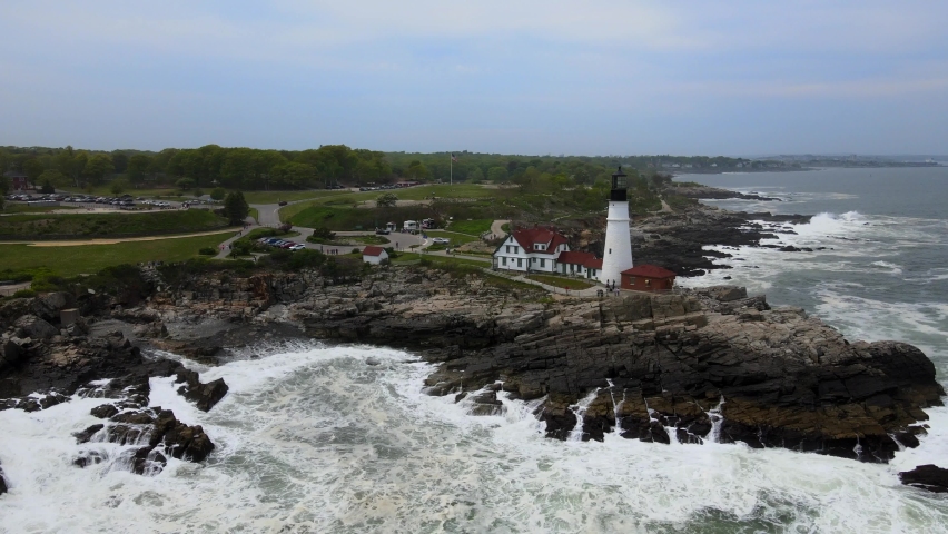 Aerial Drone Footage of the Cape Elizabeth Lighthouse on Casco Bay near Portland Maine. Rough waves on the shore of the Atlantic.