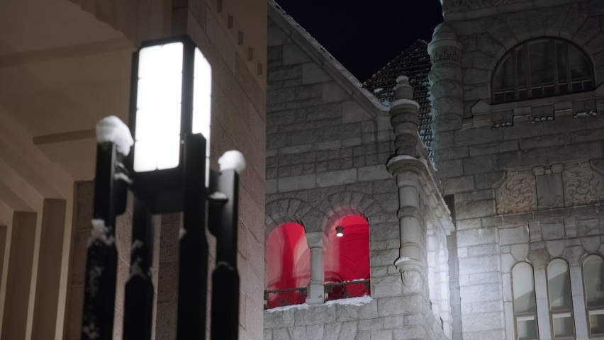 The facades of the historical buildings in Central Helsinki, Finland. In the foreground is the street lantern. 