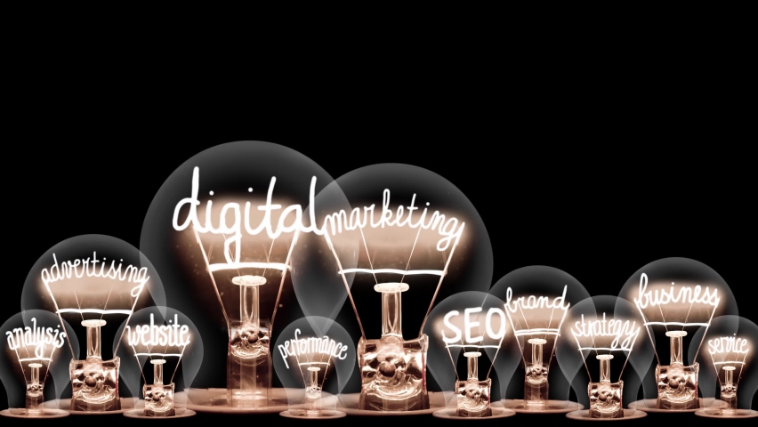 Group of light bulbs in a row going from dark to light with Digital Marketing, Brand, SEO, Business, Advertising and Strategy fiber text on black background. High quality 4k video. Royalty-Free Stock Footage #1085964074