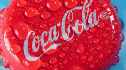 Tyumen, Russia-January 19, 2022: Coca-Cola classic cap close up in water. Coca cola is the world most selling carbonated soft drink