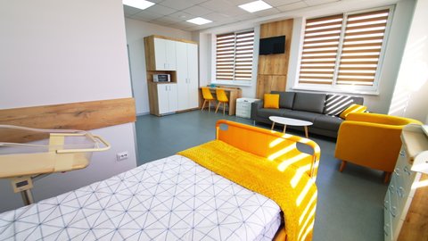 KYIV, UKRAINE - August 2021: Bright furnished chamber for comfortable staying of newly made parents and babies. Cozy room with beautiful design in maternity hospital.