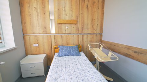 KYIV, UKRAINE - August 2021: Cozy room for mothers and their newly-born babies. Light and big ward with comfortable modern furniture.