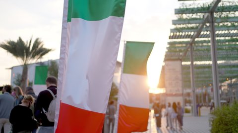 Dubai, United Arab Emirates - January 2022: Expo 2020 UAE against background of flag of Italy, Future, science technology, business people, world exhibition pavilions, education high-tech innovation