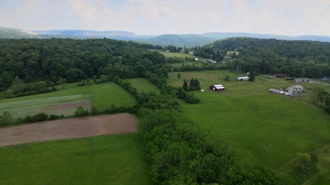 Aerial Footage of the Pennsylvania Country Side. Mountains, forests, farms, barns and tractors visible. Near Pittsburgh.