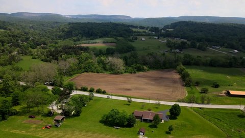 Aerial Footage of the Pennsylvania Country Side. Mountains, forests, farms, barns and tractors visible. Near Pittsburgh.
