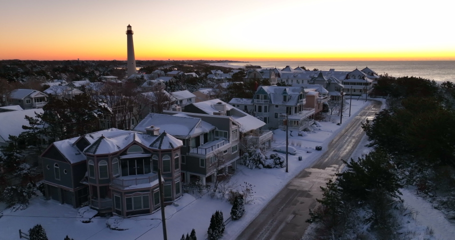 Cape May Point New Jersey. Lighthouse and vacation homes at sunrise, sunset. Winter snow.