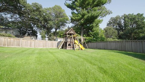 Children's Swing and Jungle Gym in the Backyard with a Slide and Monkey Bars