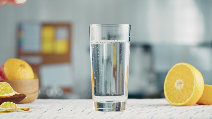 Effervescent tablet vitamin C nutritional supplements in glass with yellow carbonated water, sport medication, healthy morning. Aspirin antipyretic drugs Royalty-Free Stock Footage #1085981048
