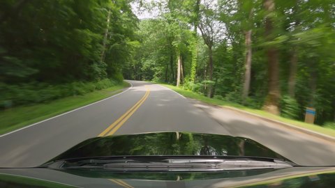 POV Driving a car on asphalt road in the middle of the forest, Great Smoky Mountains, Tennessee. Summer day, road trip concept