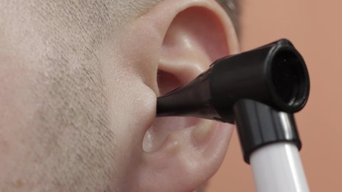 Diagnostics and examination of the patient's ear for the presence of diseases in otolaryngology, macro. Otoscope