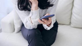 Young Asian woman using a smart phone in room.