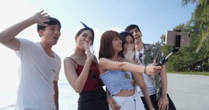 Asian young group happy expression with camera selfie and live vlog. Man and women hangout on the beach in summer season. Young happy expression and anniversary celebration.