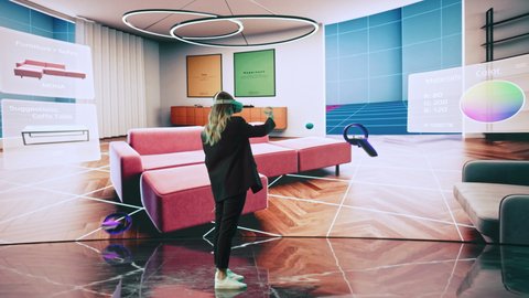 Interior Designer Using a VR Software to Design a Living Space. Change Couch Colors, Move Furniture in Interactive Environment on a Big Digital Screen. Female Engineer Using Headset and Controllers.