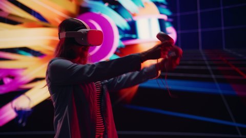 Digital Artist Using VR Software to Create a 3D Piece of Art: Designing a Stylish Futuristic Portrait in Interactive Environment on a Big Digital Screen. Female Designer Using Headset and Controllers.