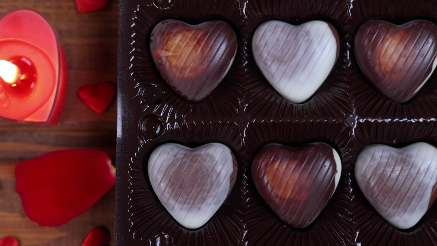 Valentines Day concept heart shaped chocolate with candles on wooden background. Love concept. Dolly shot 4k | Shutterstock HD Video #1085990774