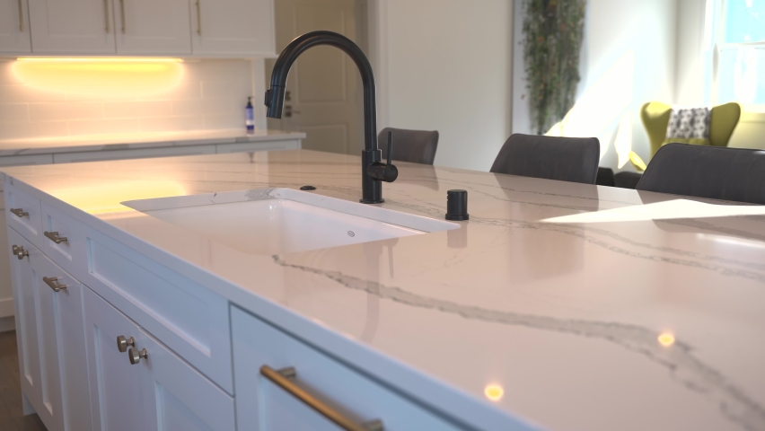 White Granite Island Top with a Modern Faucet in an Open Concept Home Royalty-Free Stock Footage #1085996837