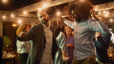 Beautiful Carefree Friends are Dancing Together and Celebrating an Evening Event at a Party. Diverse Multiethnic Young Adult People Have Fun at a Corporate Party in a Restaurant.