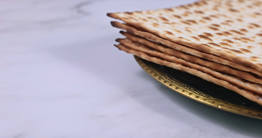 Pesach Passover celebrating symbols of great Jewish family holiday traditional matzah, seder, kippah and tallit, torah scroll Royalty-Free Stock Footage #1086005063