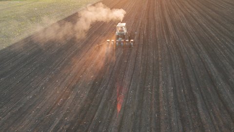 aerial view of Farmer with old tractor seeding sowing crops at agricultural fields in spring in poor countries. cultivation of land. Farmers preparing land and fertilizing. Agricultural