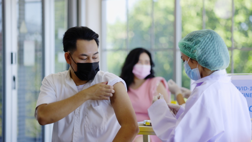 Concept Vaccination booster Covid 19. Doctor inject vaccines against new strain of covid for people in hospital station. Patient received a stimulant injection to prevent various strains of virus. Royalty-Free Stock Footage #1086005909