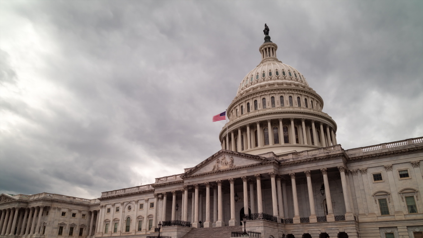 A daytime time-lapse of clouds passing over the east side of the United States Capitol Building in Washington, DC. The camera pans from left to right. Royalty-Free Stock Footage #1086006011