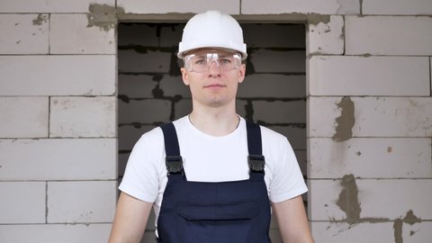 Portrait of a male construction worker in a helmet holding ing a roulette wheel.