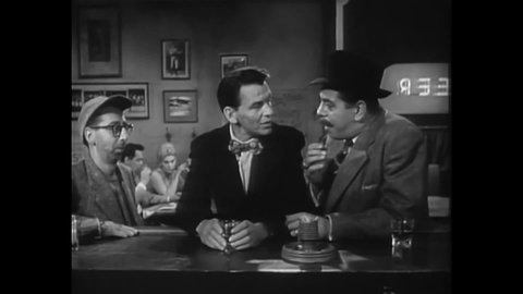 CIRCA 1955 - In this drama film, a regular at a bar makes fun of a drug dealer trying to warm up to a customer (Frank Sinatra).
