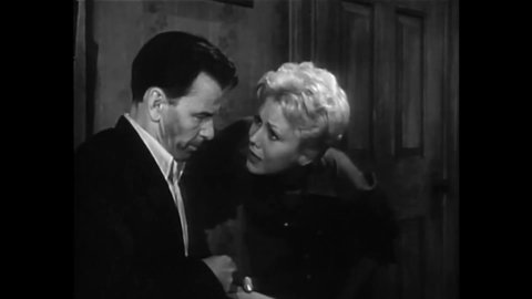 CIRCA 1955 - In this drama film, a woman (Kim Novak) tries to get her drug addict boyfriend (Frank Sinatra) to quit his habit.
