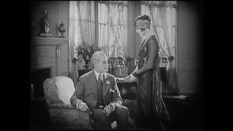 CIRCA 1925 - In this silent film, a flapper accuses her high society boyfriend of not proposing to her because he fears what society would say.