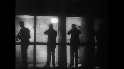 CIRCA 1936 - FBI agents use machine guns at an indoor firing range.