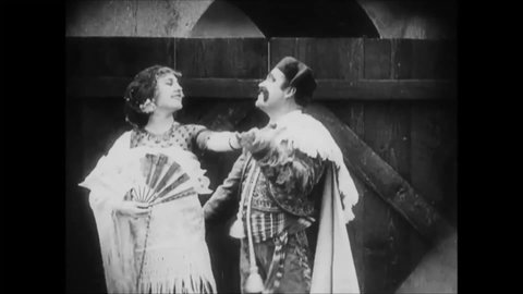 CIRCA 1915 - In this silent comedy, a peasant (Charlie Chaplin) harasses a beautiful Romani woman.