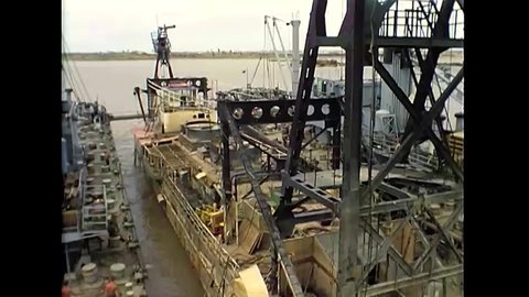 CIRCA 1969 - The USS Crandall is secured along the USS Sand Pumper in Dong Tam, Vietnam, to be salvaged.
