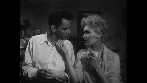 CIRCA 1955 - A man (Frank Sinatra) explains to his girlfriend (Kim Novak) how he got hooked on drugs but promises he's kicked the habit.