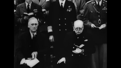 CIRCA 1941 - FDR and Winston Churchill sign the Atlantic Charter aboard a ship.