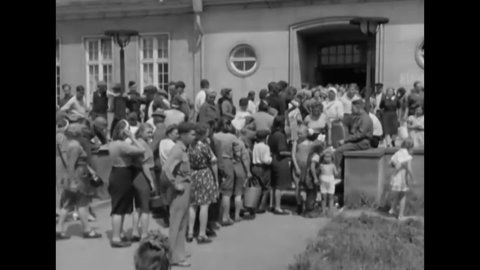 CIRCA 1945 - Refugees line up at Camp Schonau, a relocation camp in Germany.