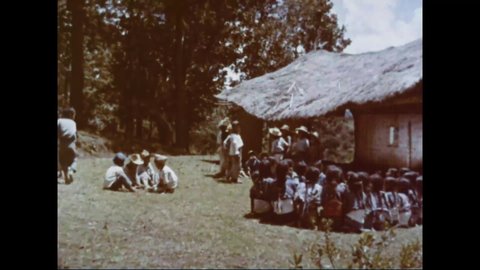 CIRCA 1960s - An educator comes to a remote Guatemalan village to teach the children.