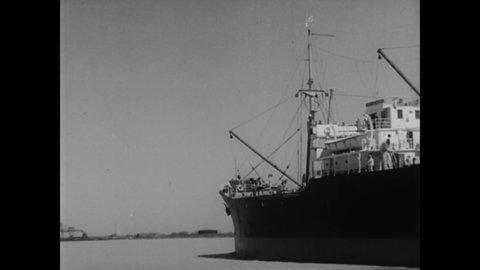 CIRCA 1933 - Merchant ships sail in and out of Mobile, Alabama.