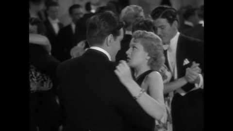 CIRCA 1939 - In this romance film, everyone at a party stops to watch a beautiful woman (Lana Turner) dance with her skilled date.