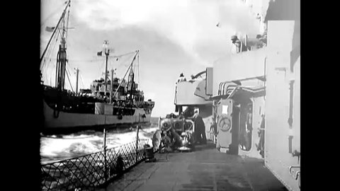 CIRCA 1950 - A fuel line is strung between the USS Hollister and USS Cacapon.
